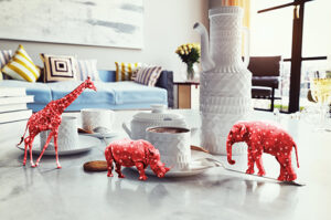 Red hearted elephant, giraffe and rhino on coffee table created by Redline company