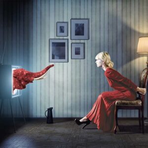Woman in red dress looking at tv where red elephant comes out created by Redline Company